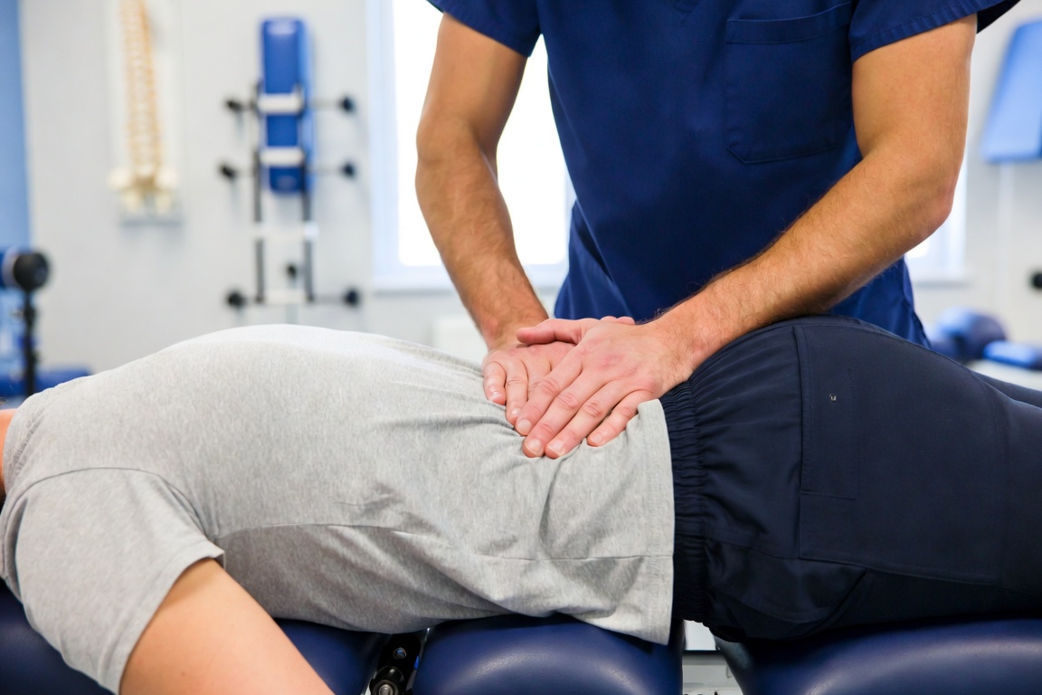 Chiropractic adjustment on a drop table at Smiley Chiropractic in Garland, TX